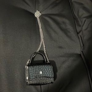 I am selling this mini black purse bought for 20$ now 15$ get it while you can